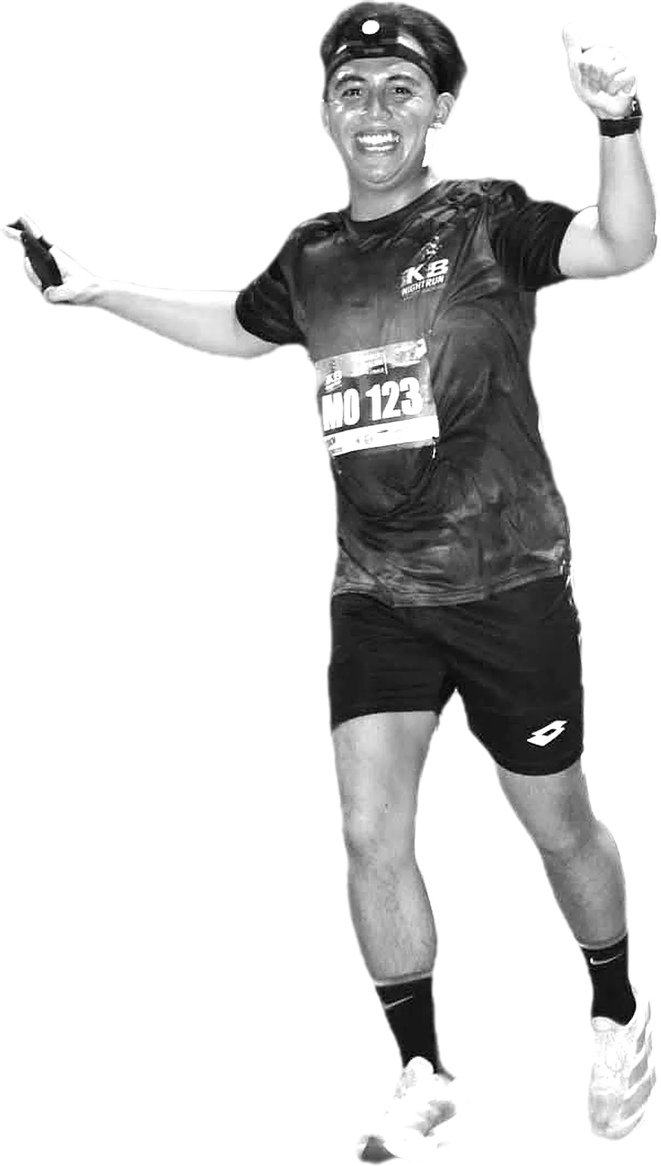 A crew runner in a headlamp giving a thumbs up mid-race